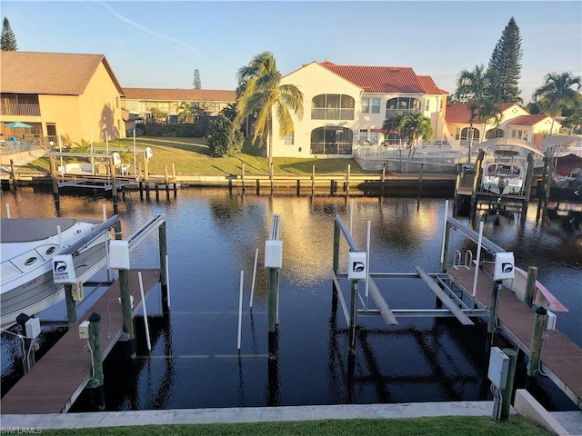 dock area featuring a yard and a water view