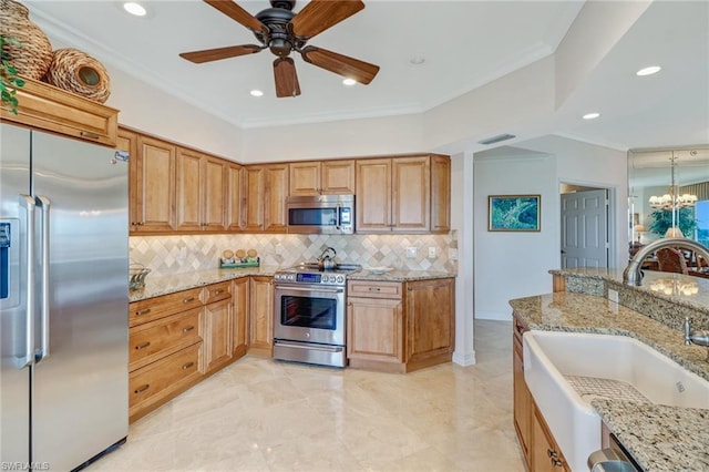 kitchen featuring appliances with stainless steel finishes, light stone countertops, ceiling fan with notable chandelier, and light tile flooring