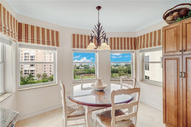 tiled dining area featuring ornamental molding and an inviting chandelier