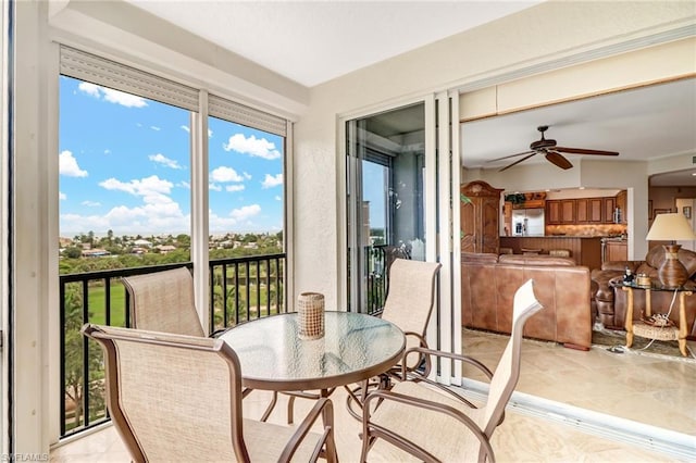 sunroom featuring ceiling fan