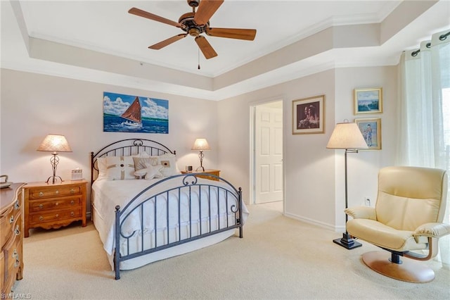 bedroom featuring light carpet, a raised ceiling, ceiling fan, and crown molding