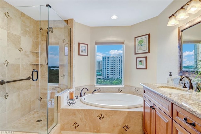 bathroom with separate shower and tub and vanity with extensive cabinet space