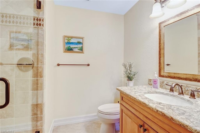 bathroom featuring toilet, vanity, and tile flooring