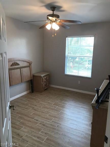 unfurnished bedroom with ceiling fan and hardwood / wood-style flooring