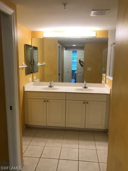 bathroom with tile flooring and dual vanity