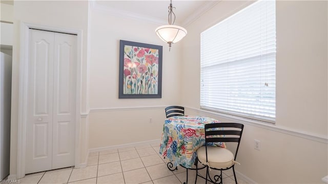 dining area featuring crown molding and light tile floors