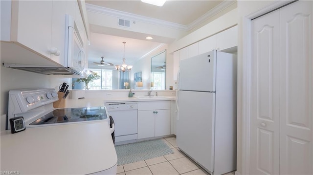 kitchen featuring white appliances, sink, light tile floors, white cabinets, and a chandelier