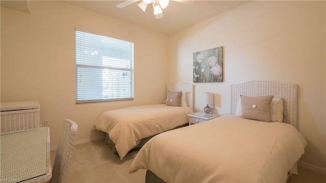 bedroom featuring light carpet and ceiling fan