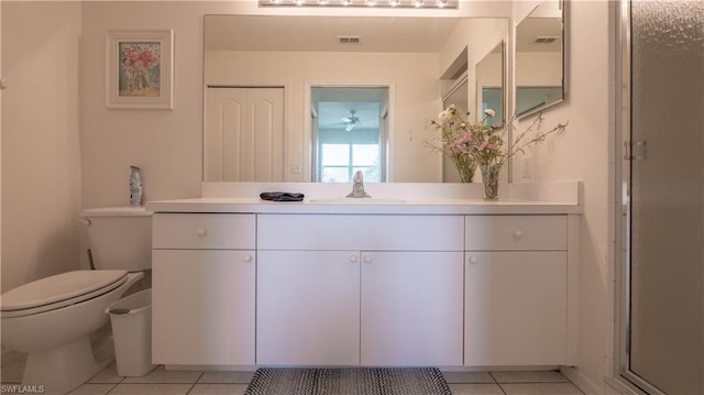 bathroom featuring vanity, tile flooring, and toilet