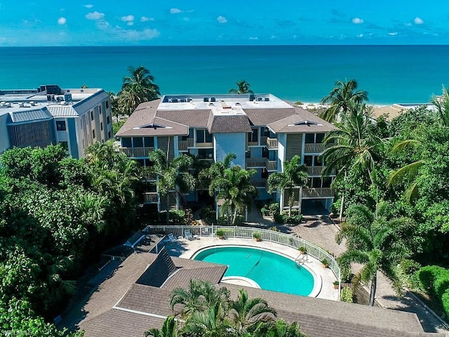 view of pool with a water view and a patio