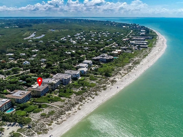 aerial view with a water view and a beach view