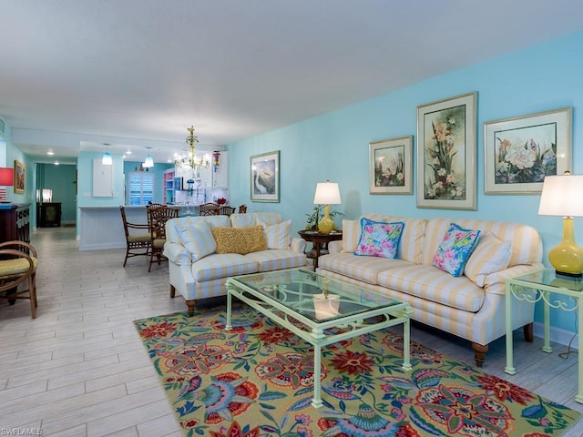 living room with a notable chandelier and light wood-type flooring