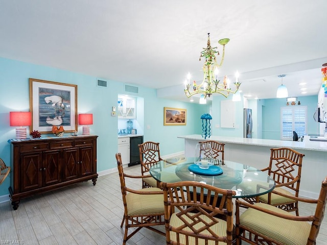 dining area with a chandelier and light wood-type flooring