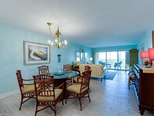 dining space featuring an inviting chandelier and light hardwood / wood-style flooring