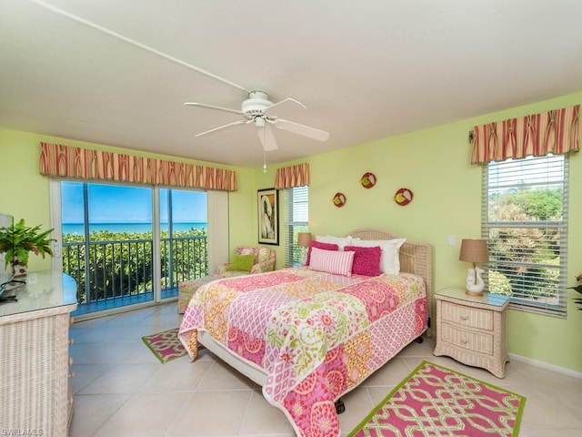 tiled bedroom with a water view, access to exterior, and ceiling fan