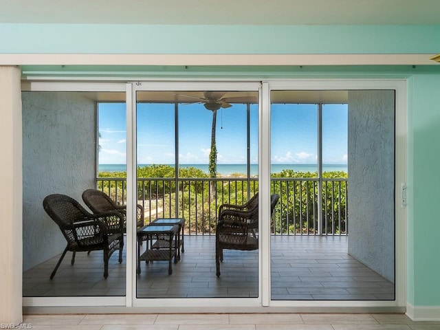 doorway to outside with a water view