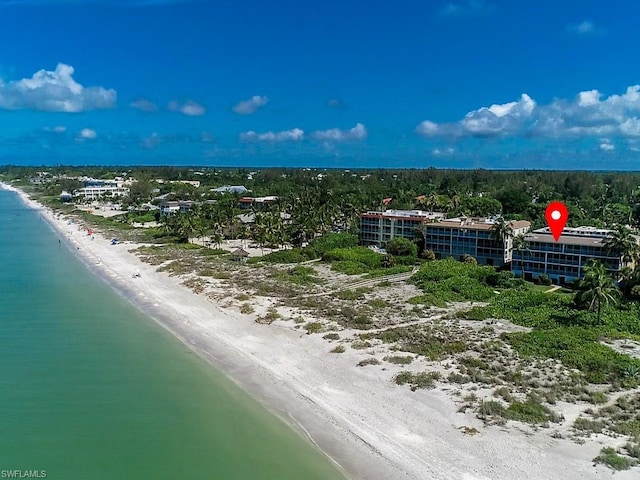 drone / aerial view featuring a water view and a view of the beach