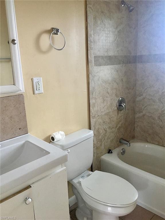 full bathroom with toilet, tiled shower / bath combo, and vanity