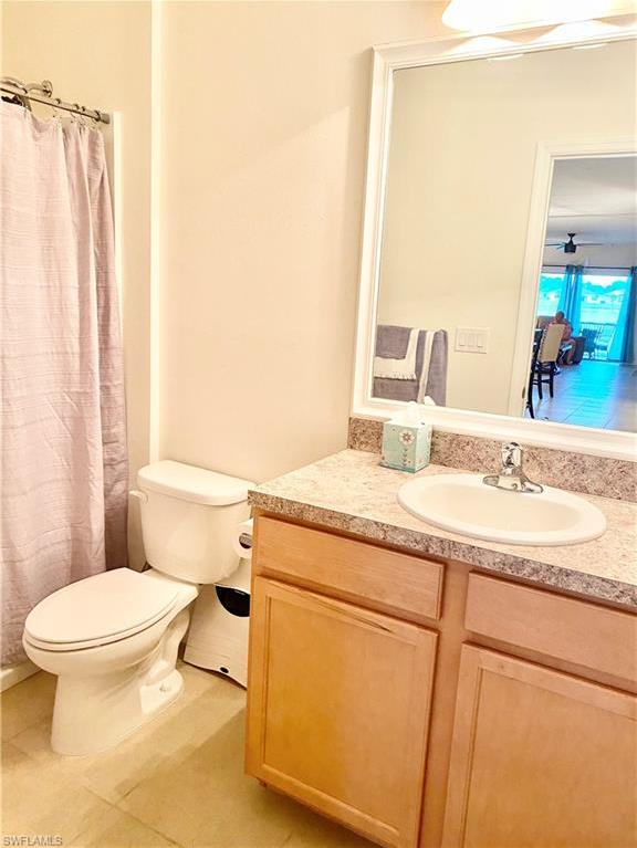 bathroom featuring vanity, tile floors, and toilet