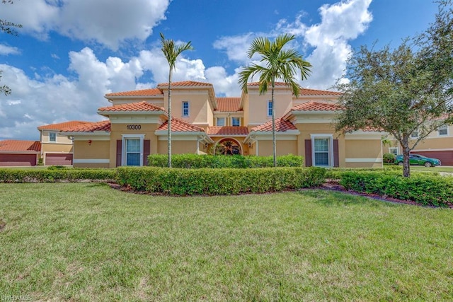 mediterranean / spanish house with a front yard