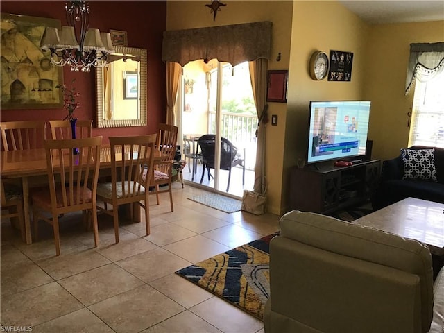 living room with an inviting chandelier and light tile floors