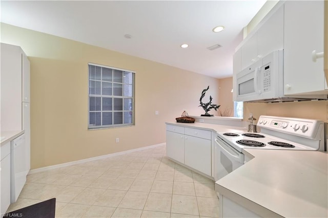 kitchen with light tile flooring, white appliances, and white cabinetry