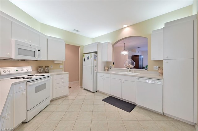 kitchen with light tile floors, white appliances, sink, white cabinets, and an inviting chandelier