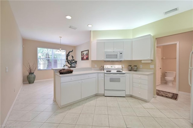 kitchen with kitchen peninsula, white appliances, light tile flooring, and white cabinets