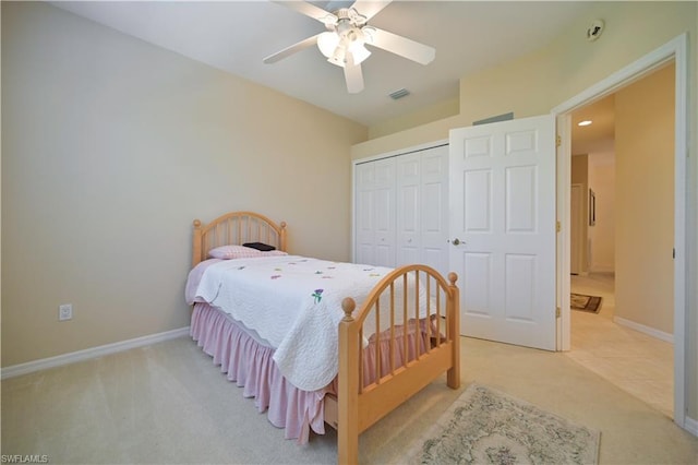 carpeted bedroom featuring a closet and ceiling fan