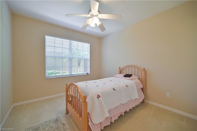 bedroom featuring light carpet and ceiling fan