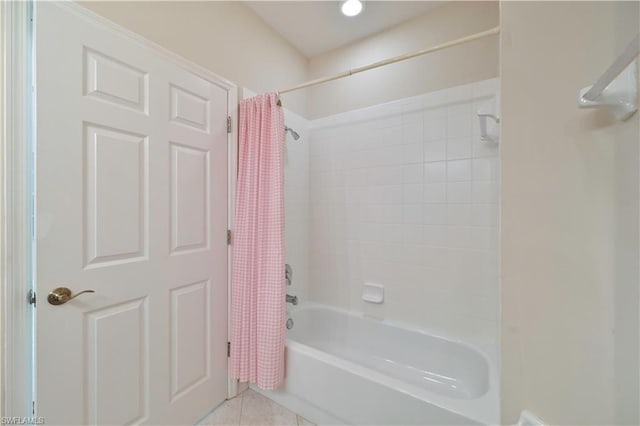 bathroom featuring tile flooring and shower / bathtub combination with curtain