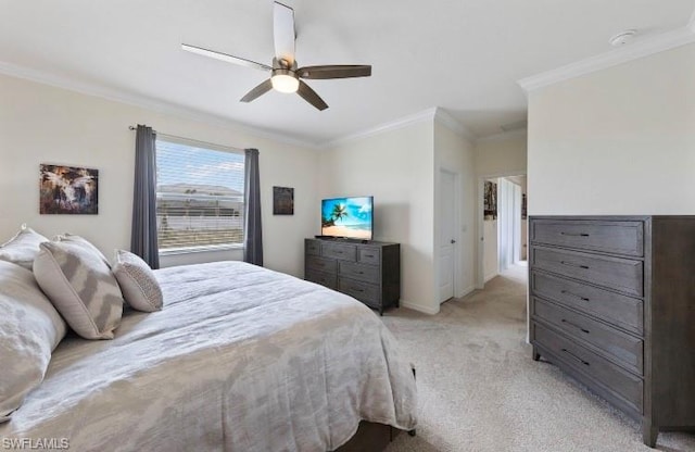 carpeted bedroom with ornamental molding and ceiling fan