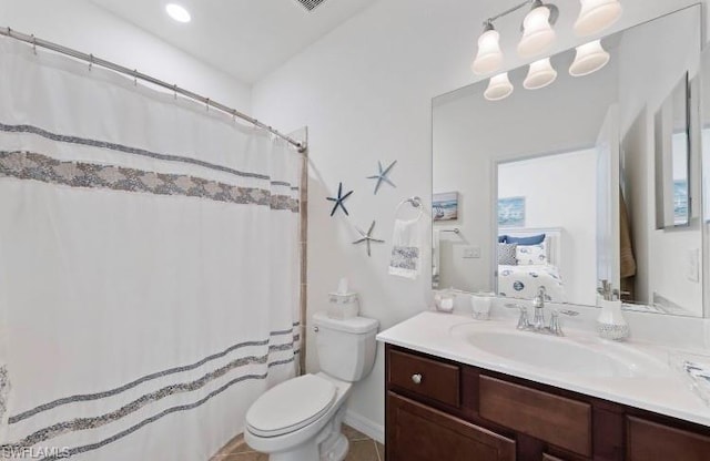 bathroom with toilet, tile floors, and oversized vanity