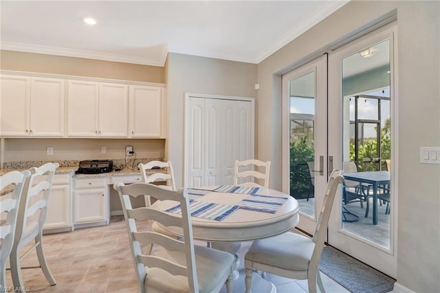 tiled dining space featuring crown molding and french doors