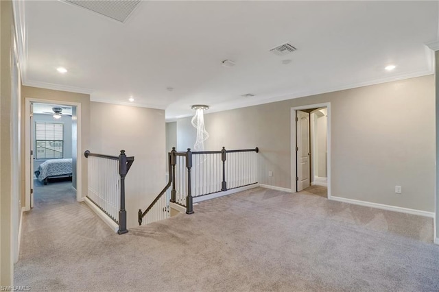 empty room with light carpet, ornamental molding, and ceiling fan