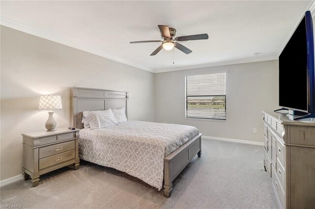 bedroom with ornamental molding, light colored carpet, and ceiling fan