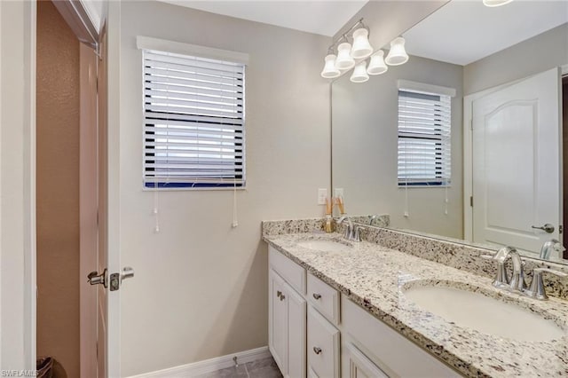 bathroom with tile floors, double vanity, and a wealth of natural light