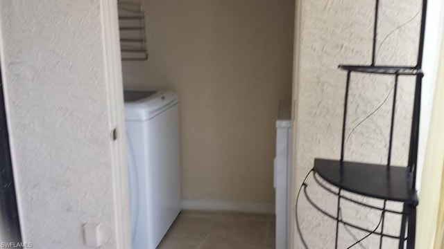 laundry room with tile floors and washer / clothes dryer