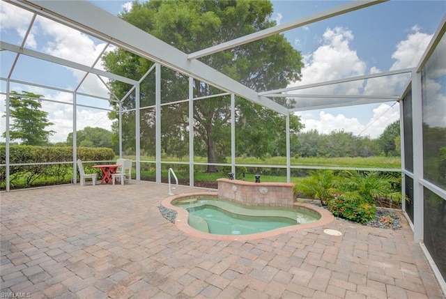 view of pool featuring a patio area, a jacuzzi, and glass enclosure