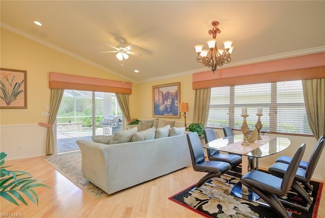 living room with lofted ceiling, crown molding, ceiling fan with notable chandelier, and light hardwood / wood-style flooring