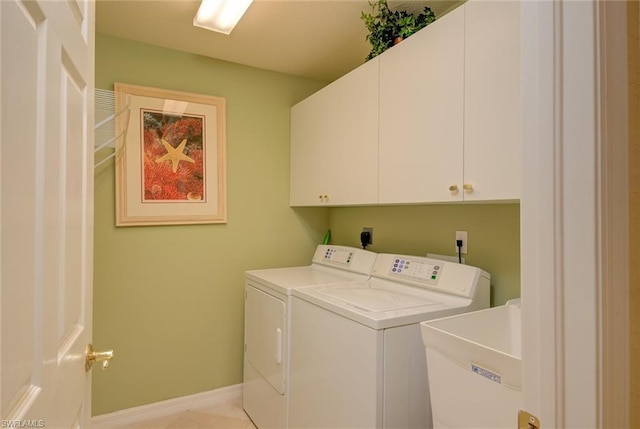 clothes washing area featuring washing machine and dryer, hookup for an electric dryer, cabinets, and sink