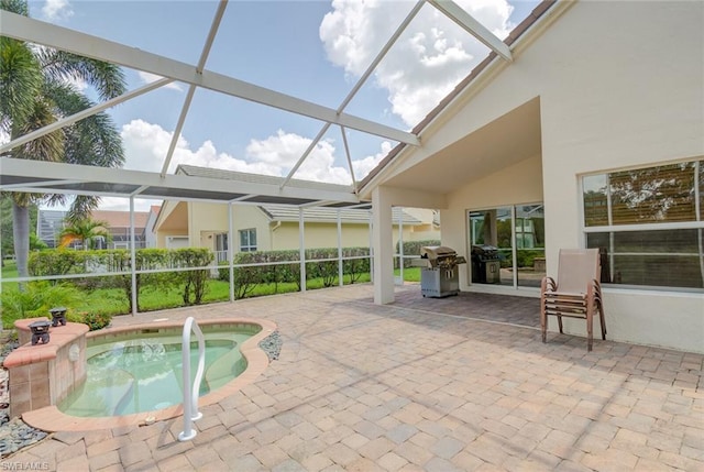 view of pool with a lanai, a hot tub, and a patio area