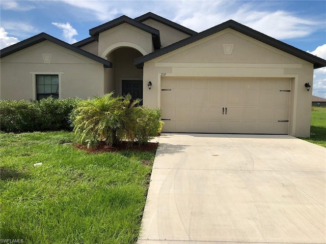 single story home featuring a front yard and a garage