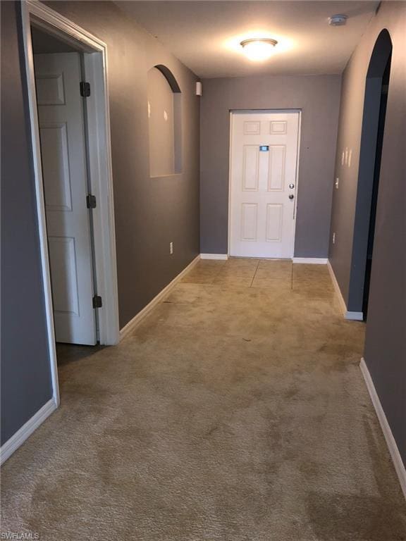 doorway featuring light colored carpet