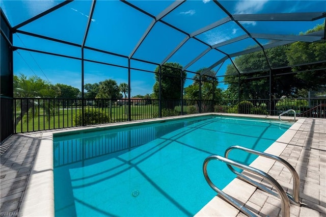 view of swimming pool featuring a lanai and a patio area