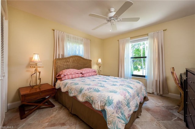 bedroom featuring light tile floors, a closet, and ceiling fan