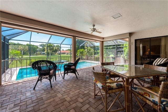 sunroom featuring ceiling fan