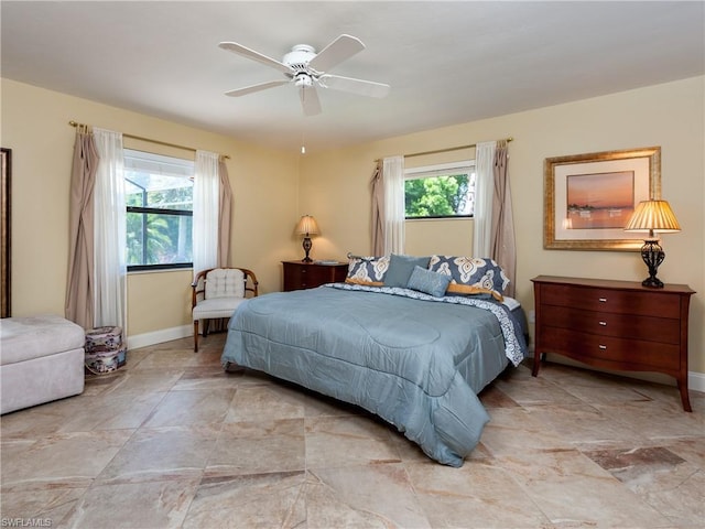 tiled bedroom featuring ceiling fan