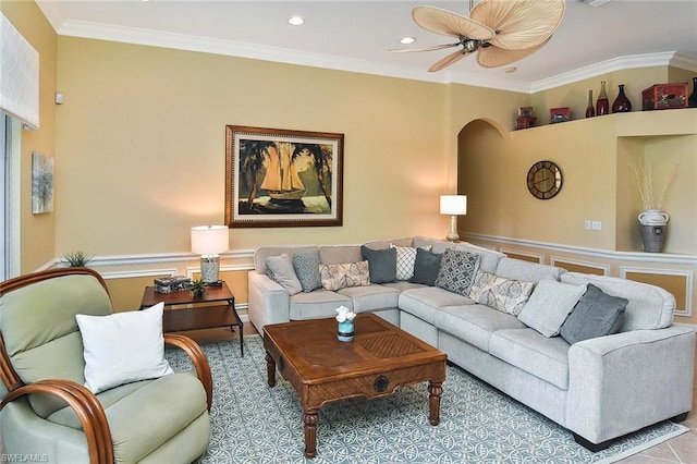 living room featuring crown molding and ceiling fan