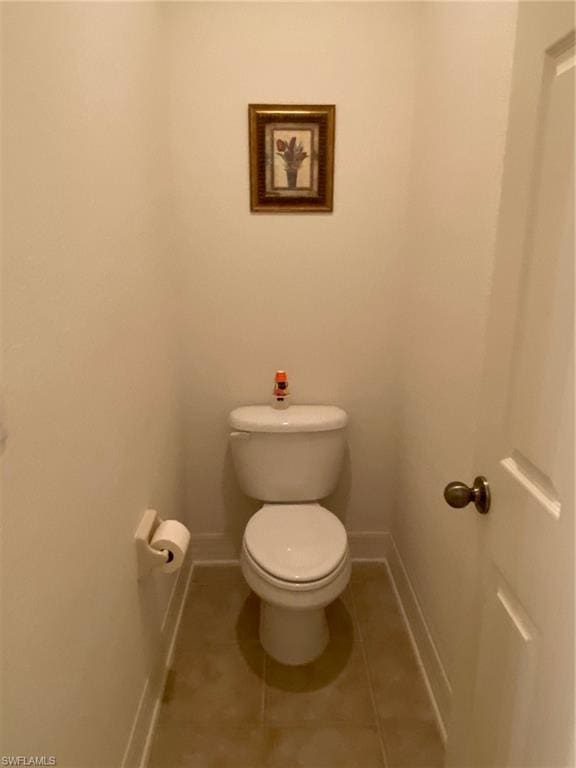 bathroom with toilet and tile flooring